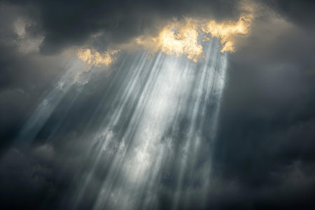Dramatic stormy sky with dark clouds and rays of light