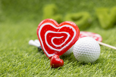Golf ball with love shape lollipop for golfer on Valentine's dayの写真素材