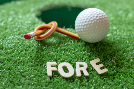 Fore word with golf ball is on green grassの写真素材