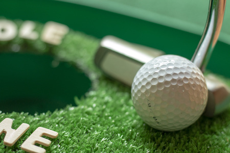 Putter is putting golf ballの写真素材