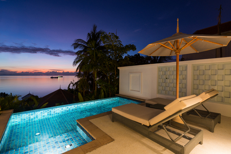 Swimming pool with sunset view at Regent Phuket Cape Panwa, Phuket, Thailand.のeditorial素材
