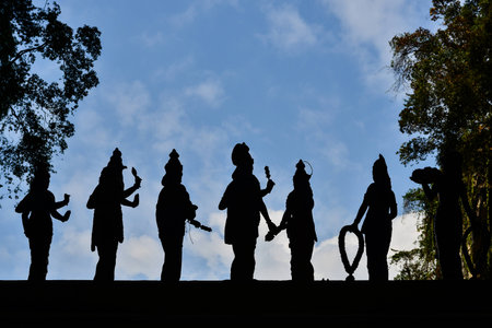 Silhouette of statue with blue sky background at Batu Cave, Kuala Lumpur, Malaysiaの写真素材