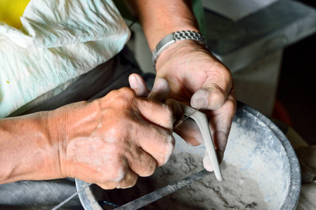 Thai people making earthenware spoon in Thailandの写真素材