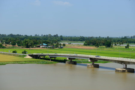 Bridge over there river with green field, Thailandの写真素材