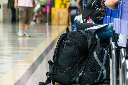 Backpack and passengers waiting in the station