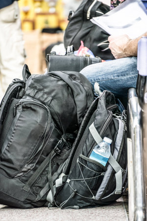 Backpack and passengers waiting in the stationの写真素材