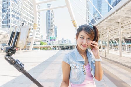Pretty girl taking a selfie with smartphoneの写真素材