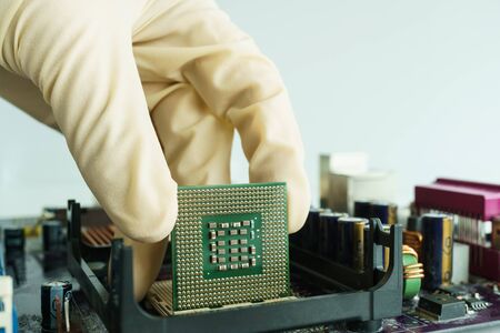 take microprocessor from main board by handの写真素材