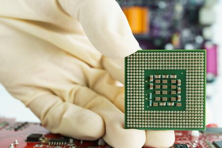 take microprocessor and show with handの写真素材