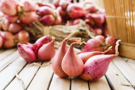 heap of onions on bamboo floorの写真素材