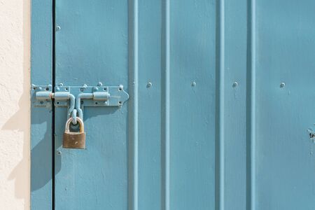 blue metal door with padlock texture and backgroundの写真素材