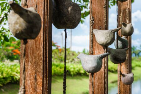 birds carved by wooden hang on wood in the garden wooden birdsの写真素材