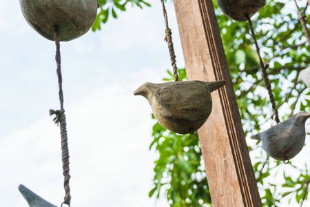 birds carved by wooden hang on wood in the garden wooden birdsの写真素材
