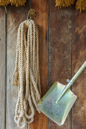 Farm tools, Rope and Shovel hang on the wooden wallの写真素材