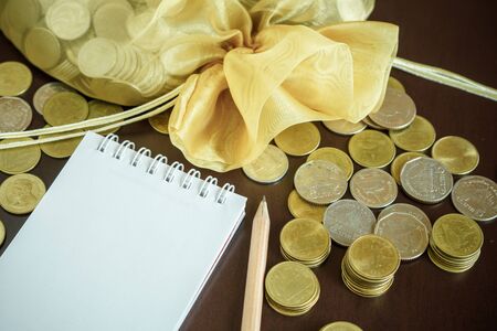Saving money with writing income and expense on notebookの写真素材