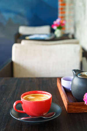Coffee red cup in coffee shop; Coffee break with teapotの写真素材