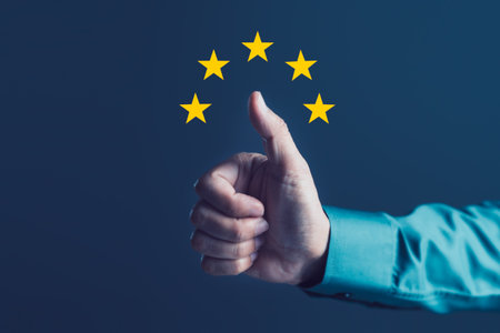 Close-up of hand showing thumbs up with five golden stars above, excellent customer rating, high satisfaction, quality service, user trust, outstanding productの写真素材