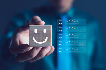 Businessman holding wooden cube with smiley face symbol and digital review charts in background, customer satisfaction, product feedback, service quality, review analytics, user experience insightsの写真素材