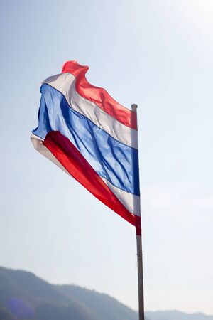 Image of waving Thai flag of Thailand with blue sky background