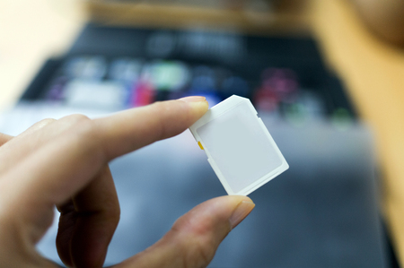 Hand holding an SD cardの写真素材