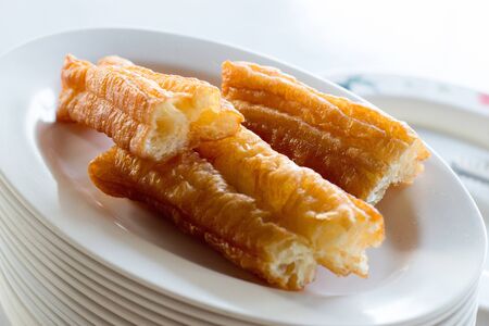 Snack and Dessert, Top View of Chinese Traditional Snacks Deep Fried Dough Stick on A White Plate.の写真素材