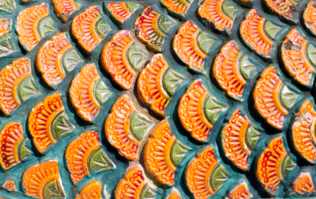 Thai flower pattern Embossed cement paint with gold yellow and green color background in temple.の写真素材