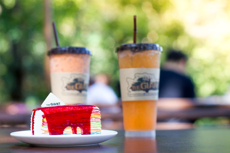 CHIANGMAI, THAILAND - MARCH 3: Giant Tree Coffee Shop Mae Kampong on March 3,2018 in Chiangmai, Thailand. Beautiful Rainbow Crepe Cake, Cup of Ice Tea and Ice Orange Juice Served for the tourist.のeditorial素材