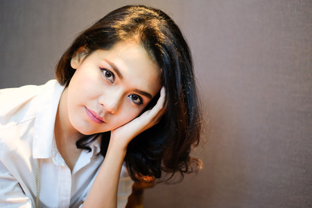 Asian Female Models Portrait Face is Sitting with gray background. Selective focus Image.の写真素材