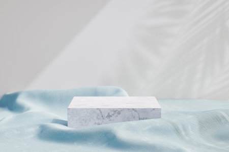 Cosmetic display product stand, White marble podium with blue fabric on light background. 3D rendering illustrationの写真素材