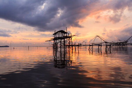 silhouette House's fishing at sunrise in Asia.の写真素材