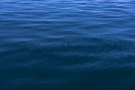 Blue water background with ripples Sea low angle view, Ocean, Wave.   Travel destination and nature...