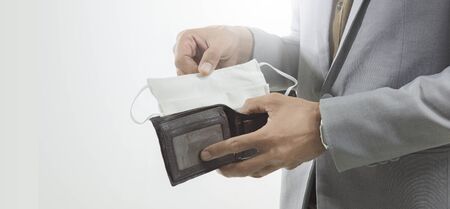 Poverty and absence of money. Unemployed sad guy showing mask in wallet isolate on white background,...