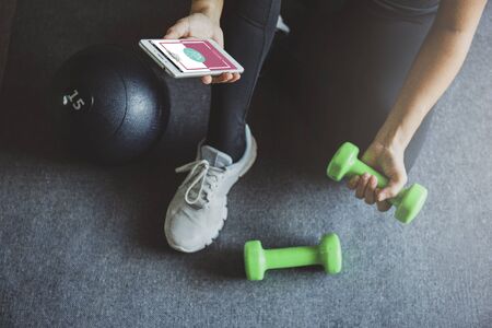 Young woman shopping online  while resting after workout at home.Online shopping and modern lifestyle concept.Copy spaceの写真素材
