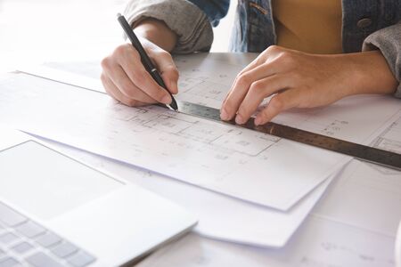 Architect engineer working on house blueprint of real estate project at workplace. construction & building concept.の写真素材