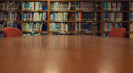 A Wood desk and bookshelf in the library room, Education Concept.の写真素材