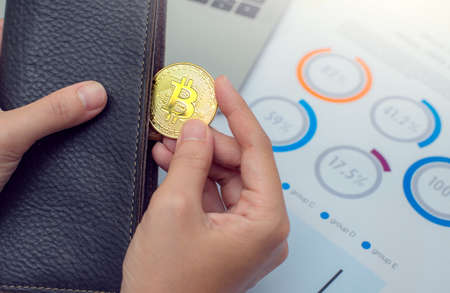 Businessman holding bitcoin coins out of wallet. Virtual currency. Crypto currency. New virtual...
