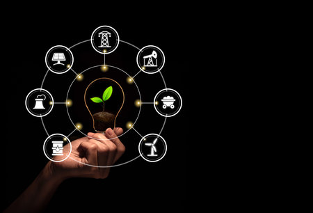 Hand holding bulb with fresh green leaf inside isolate black background with icons energy sources...