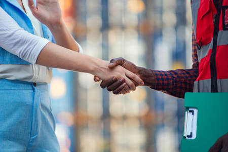 The manager greets the foreman. Shake handsの写真素材