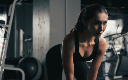 Close-up young woman lifts single kettlebell in the gym.の写真素材