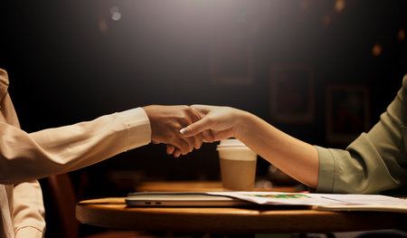 Two Businesswoman shaking hands as sign of successful negotiations.の写真素材