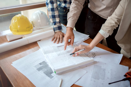 Team of architect and engineer working and discussing about new startup project on desk. Architect discuss with engineer about project  in office.の写真素材