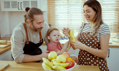Happy family eating fruits in the kitchen.の写真素材