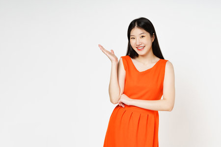 Young woman presenting or showing open hand palm with copy space for product isolated on white background.の写真素材
