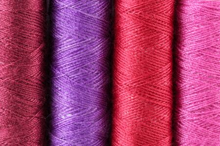 closeup of colorful threads viloet, red ,pink,dark red の写真素材