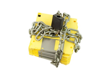 diskette fastened by chain and locked by key (in concept of data security)の写真素材