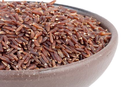 Closeup of uncooked Thai brown rice in bowlの写真素材