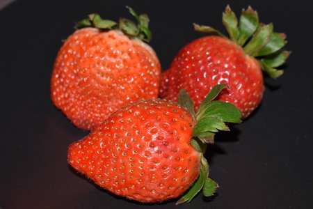 Strawberries isolate on black backgroundの写真素材