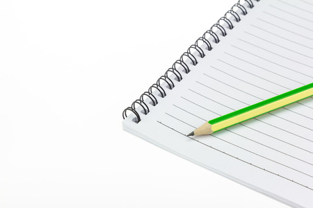Pencil put on Paper note book  on white backgroundの写真素材