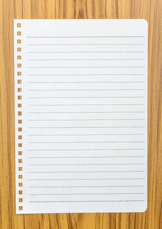 Notebook paper on wood backgroundの写真素材