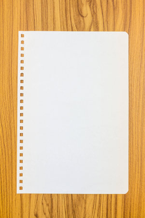 Notebook paper on wood backgroundの写真素材